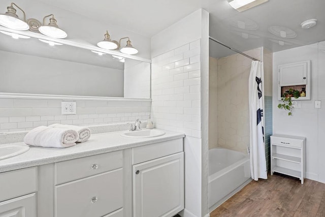 3129 E 34th Ave, Spokane, WA 99223 - full bath with double vanity, wood finished floors, decorative backsplash, and shower / bath combo
