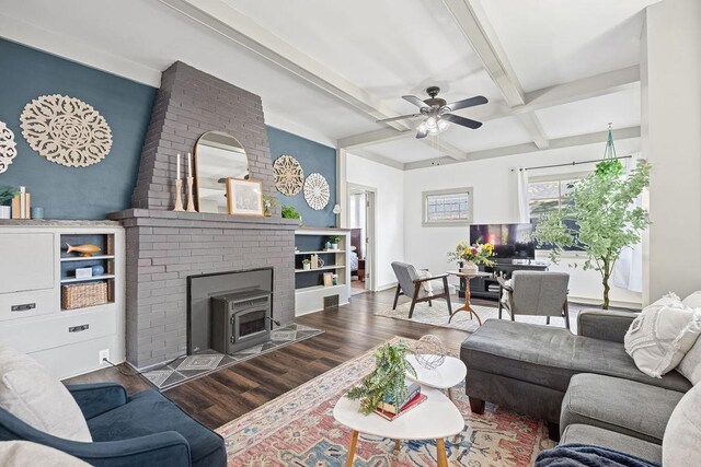 3129 E 34th Ave, Spokane, WA 99223 - living room featuring wood finished floors, beamed ceiling, a ceiling fan, a wood stove, and coffered ceiling