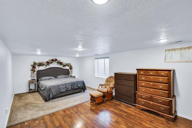 5917 N Addison St, Spokane, WA 99208 - bedroom with a textured ceiling and dark wood-style flooring