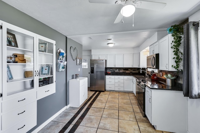 5917 N Addison St, Spokane, WA 99208 - kitchen featuring stainless steel appliances, dark countertops, backsplash, and white cabinets