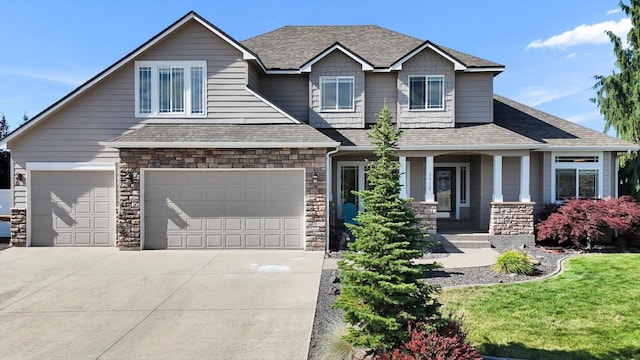 2312 W Abigail Ct, Spokane, WA 99208 - craftsman house with a porch, stone siding, a garage, and concrete driveway