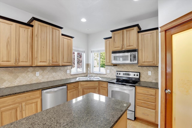 2312 W Abigail Ct, Spokane, WA 99208 - kitchen featuring stainless steel appliances, light brown cabinets, dark stone counters, and recessed lighting