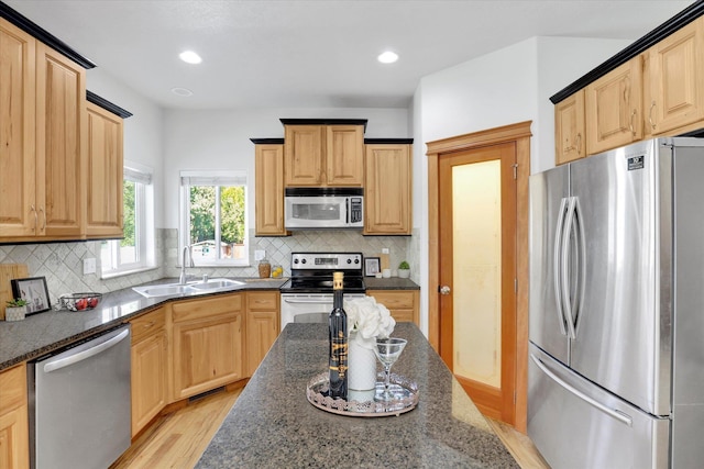 2312 W Abigail Ct, Spokane, WA 99208 - kitchen with stainless steel appliances, light brown cabinetry, dark stone counters, and recessed lighting