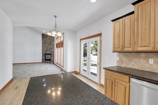 2312 W Abigail Ct, Spokane, WA 99208 - kitchen with dishwasher, light wood-style floors, a chandelier, decorative backsplash, and lofted ceiling