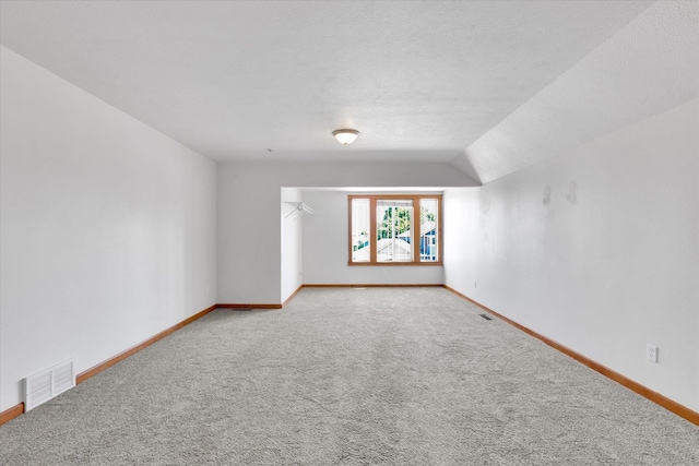 2312 W Abigail Ct, Spokane, WA 99208 - carpeted empty room featuring baseboards and vaulted ceiling