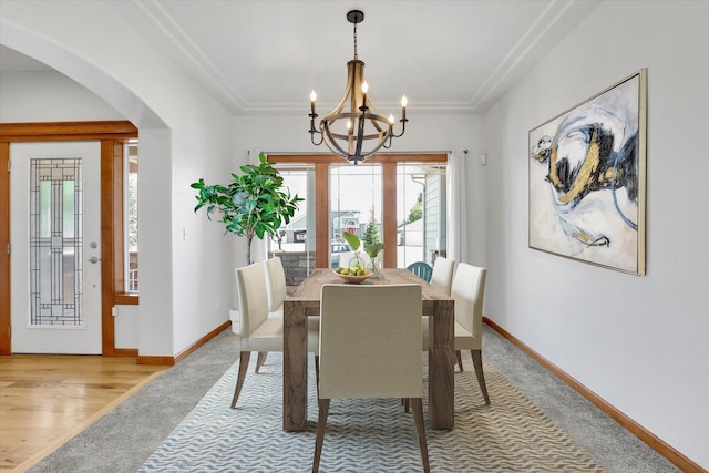 2312 W Abigail Ct, Spokane, WA 99208 - dining space with arched walkways, a chandelier, and carpet floors