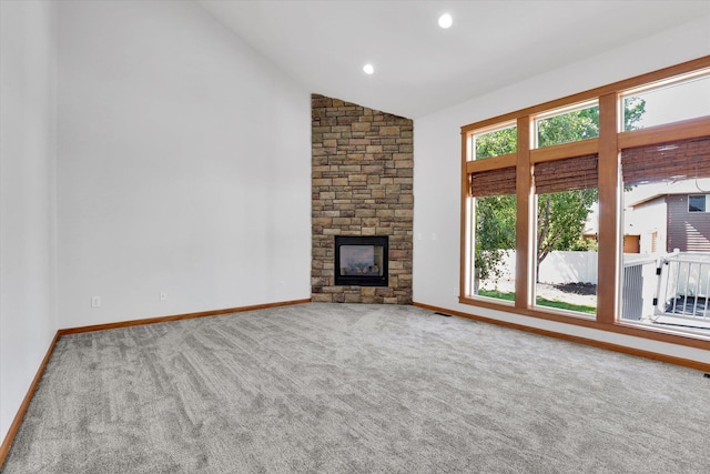 2312 W Abigail Ct, Spokane, WA 99208 - unfurnished living room with vaulted ceiling, carpet floors, and a fireplace