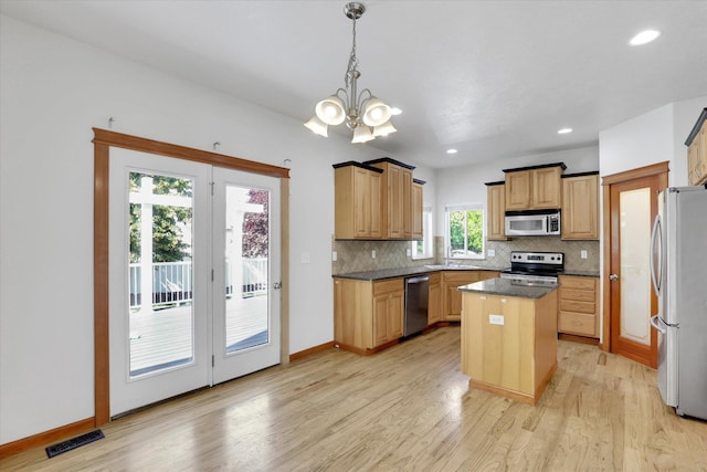 2312 W Abigail Ct, Spokane, WA 99208 - kitchen featuring appliances with stainless steel finishes, a center island, tasteful backsplash, a chandelier, and recessed lighting