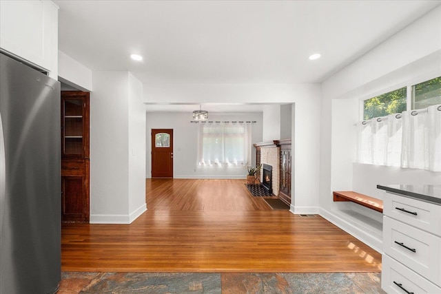 1728 S Adams St, Spokane, WA 99203 - unfurnished living room featuring wood finished floors, recessed lighting, and a fireplace