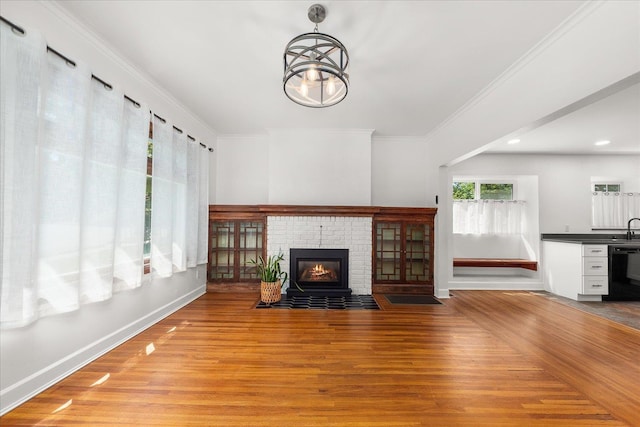 1728 S Adams St, Spokane, WA 99203 - unfurnished living room featuring light wood-style floors, crown molding, a brick fireplace, and recessed lighting