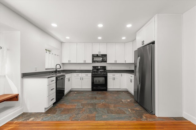 1728 S Adams St, Spokane, WA 99203 - kitchen with black appliances, dark countertops, white cabinets, recessed lighting, and dark stone finish flooring