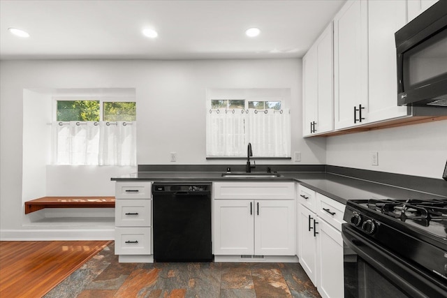 1728 S Adams St, Spokane, WA 99203 - kitchen with black appliances, dark countertops, white cabinets, recessed lighting, and dark stone finish floors