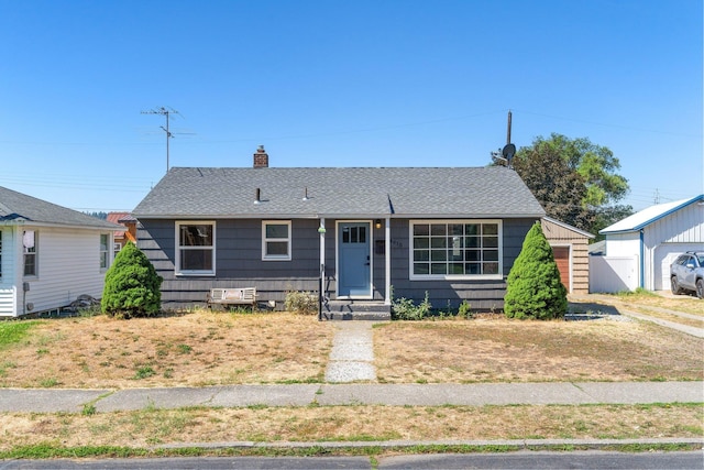 4615 N King Ct, Spokane, WA 99205 - view of front of home with a chimney, roof with shingles, entry steps, and a garage