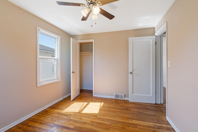 4615 N King Ct, Spokane, WA 99205 - unfurnished bedroom with wood finished floors, a closet, and a ceiling fan