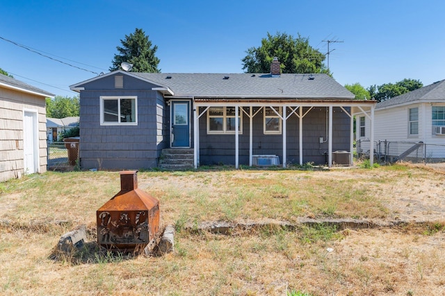 4615 N King Ct, Spokane, WA 99205 - rear view of property featuring a chimney, roof with shingles, and entry steps