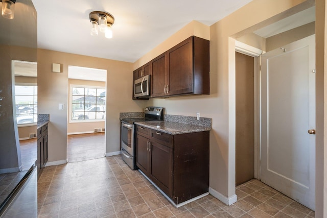 4615 N King Ct, Spokane, WA 99205 - kitchen with stainless steel appliances, dark brown cabinetry, and dark stone counters