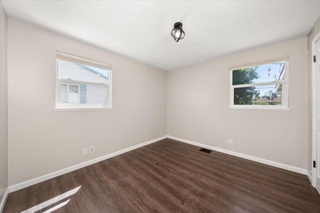 1634 E Dalke Ave, Spokane, WA 99208 - unfurnished room with healthy amount of natural light and dark wood finished floors