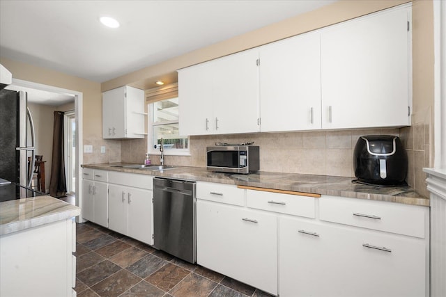 1634 E Dalke Ave, Spokane, WA 99208 - kitchen with stainless steel appliances, backsplash, white cabinets, and recessed lighting