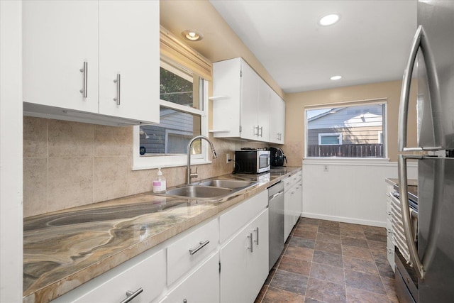 1634 E Dalke Ave, Spokane, WA 99208 - kitchen featuring stainless steel appliances, backsplash, white cabinets, recessed lighting, and dark stone finish floors