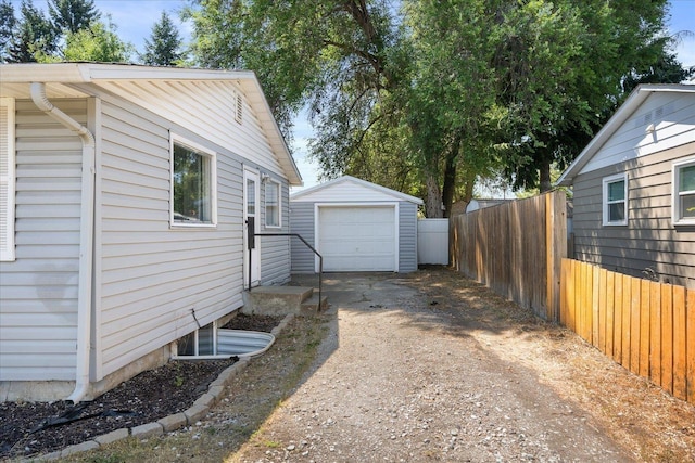 1634 E Dalke Ave, Spokane, WA 99208 - view of side of property with dirt driveway, an outdoor structure, and a detached garage