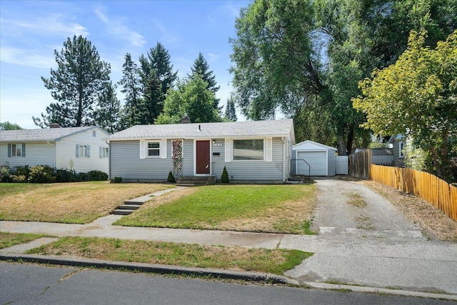 1634 E Dalke Ave, Spokane, WA 99208 - view of front facade featuring driveway, an outbuilding, a garage, a chimney, and entry steps