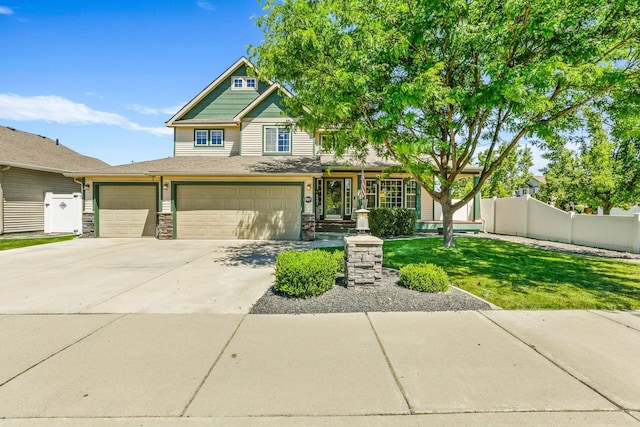 12837 E 37th Ln, Spokane Valley, WA 99206 - view of front of house with driveway, stone siding, and an attached garage
