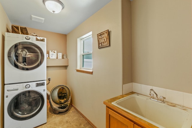 12837 E 37th Ln, Spokane Valley, WA 99206 - washroom featuring stacked washer / drying machine and cabinet space