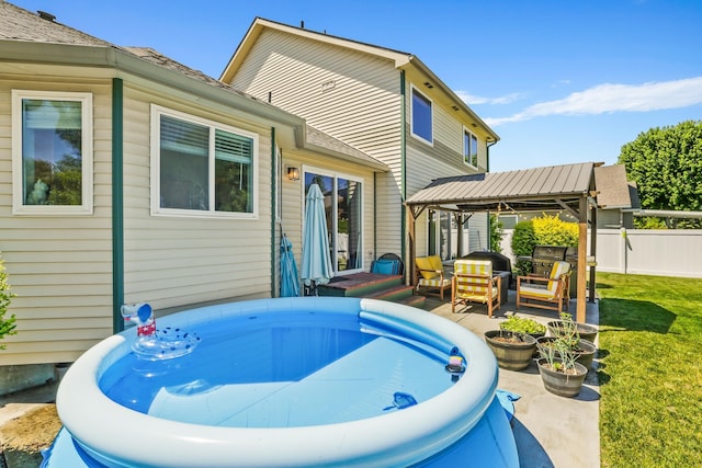 12837 E 37th Ln, Spokane Valley, WA 99206 - back of property with a gazebo, a jacuzzi, and outdoor lounge area