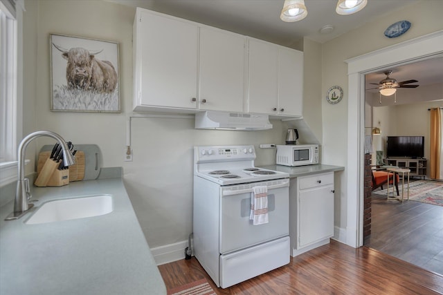 4028 N Post St, Spokane, WA 99205 - kitchen featuring white appliances, under cabinet range hood, light countertops, and dark wood-style flooring