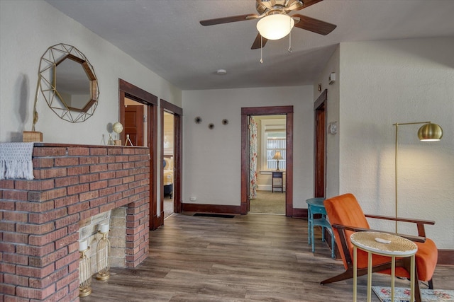 4028 N Post St, Spokane, WA 99205 - living area featuring wood finished floors, a ceiling fan, and a fireplace