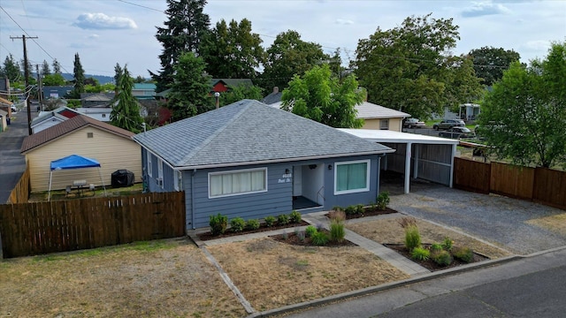 4028 N Post St, Spokane, WA 99205 - bungalow-style house featuring a shingled roof, a carport, and driveway