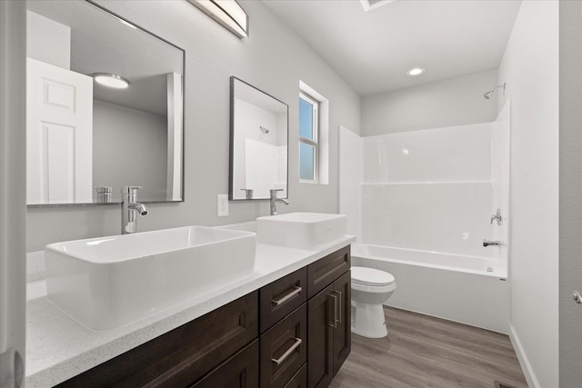 2912 E Wabash Ave, Spokane, WA 99217 - bathroom with double vanity, wood finished floors, and shower / bath combination