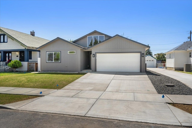 2912 E Wabash Ave, Spokane, WA 99217 - view of front facade featuring a front yard, a garage, and concrete driveway