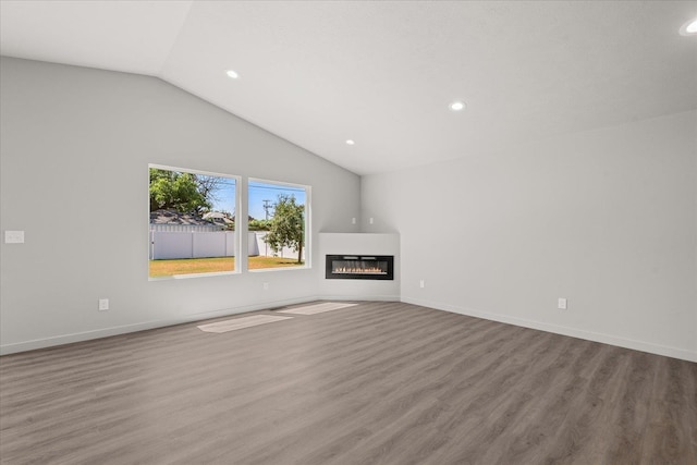 2912 E Wabash Ave, Spokane, WA 99217 - unfurnished living room with vaulted ceiling, recessed lighting, wood finished floors, and a glass covered fireplace