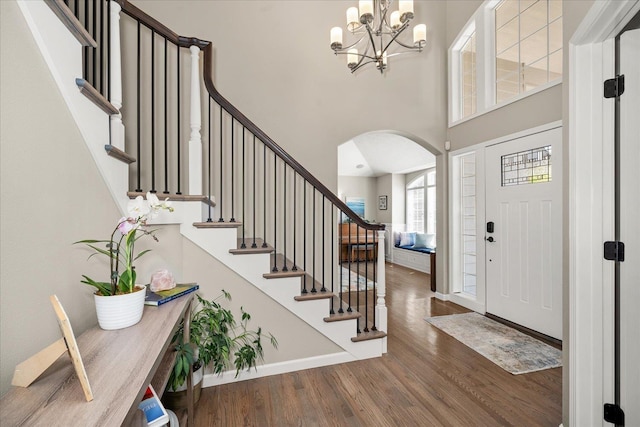 5203 S S Hogan Ct, Spokane, WA 99223 - foyer with arched walkways, wood finished floors, a towering ceiling, a chandelier, and stairs