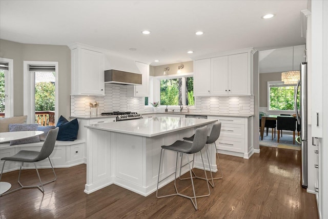 5203 S S Hogan Ct, Spokane, WA 99223 - kitchen with dark wood finished floors, white cabinets, light countertops, tasteful backsplash, and a kitchen island