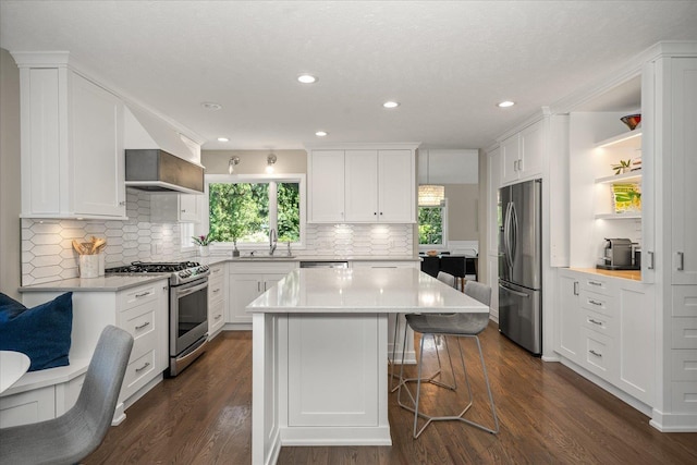 5203 S S Hogan Ct, Spokane, WA 99223 - kitchen with appliances with stainless steel finishes, open shelves, light countertops, plenty of natural light, and recessed lighting
