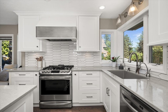5203 S S Hogan Ct, Spokane, WA 99223 - kitchen featuring appliances with stainless steel finishes, custom exhaust hood, decorative backsplash, light stone countertops, and white cabinets
