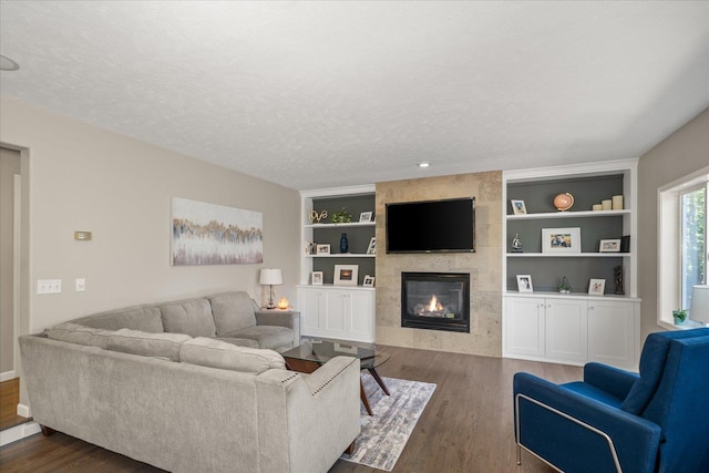 5203 S S Hogan Ct, Spokane, WA 99223 - living area with a tile fireplace, dark wood finished floors, built in shelves, and a textured ceiling