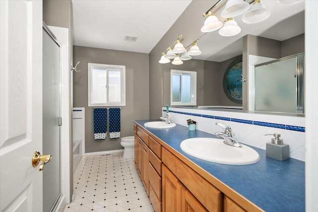 5203 S S Hogan Ct, Spokane, WA 99223 - bathroom featuring a shower with door, a chandelier, double vanity, and backsplash