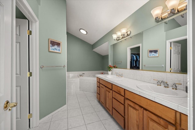 5203 S S Hogan Ct, Spokane, WA 99223 - full bathroom with tile patterned floors, a bath, double vanity, vaulted ceiling, and a spacious closet