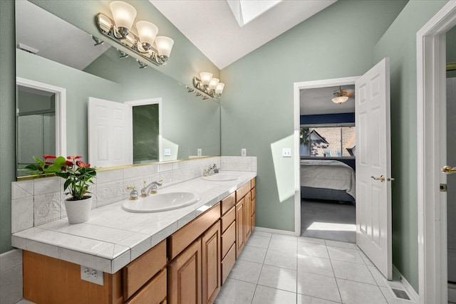 5203 S S Hogan Ct, Spokane, WA 99223 - ensuite bathroom with lofted ceiling, double vanity, tile patterned flooring, and a skylight