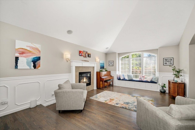 5203 S S Hogan Ct, Spokane, WA 99223 - living area featuring vaulted ceiling, wood finished floors, wainscoting, a tile fireplace, and a decorative wall
