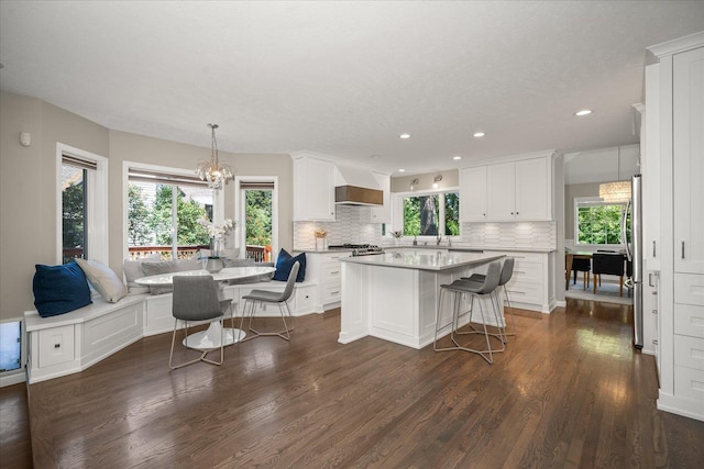 5203 S S Hogan Ct, Spokane, WA 99223 - kitchen featuring tasteful backsplash, dark wood-type flooring, a center island, white cabinets, and recessed lighting
