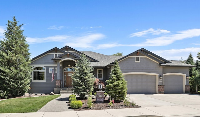 1604 N Rim View St, Spokane, WA 99224 - craftsman-style home with an attached garage, concrete driveway, and brick siding