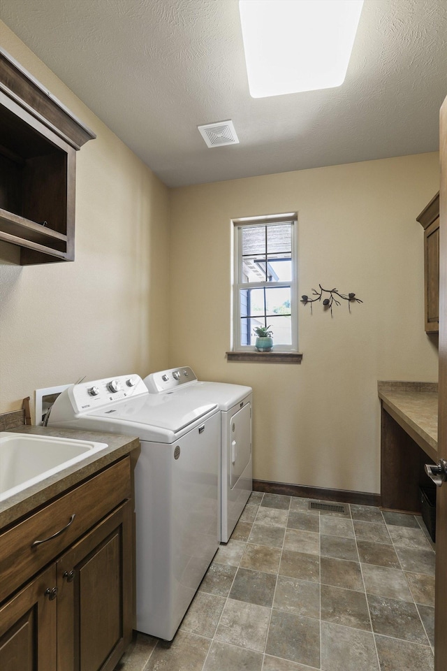1604 N Rim View St, Spokane, WA 99224 - laundry room featuring washing machine and dryer and cabinet space