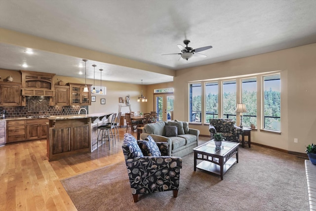 1604 N Rim View St, Spokane, WA 99224 - living room with a ceiling fan, light wood-style floors, and a chandelier