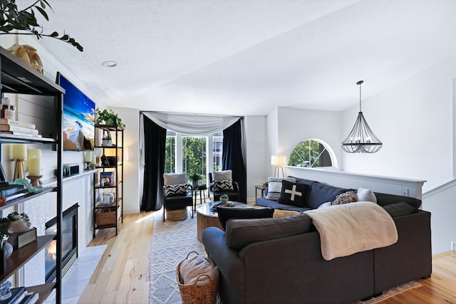 18017 N Lidgerwood Ct, Colbert, WA 99005 - living area with a chandelier, light wood-style flooring, and a glass covered fireplace