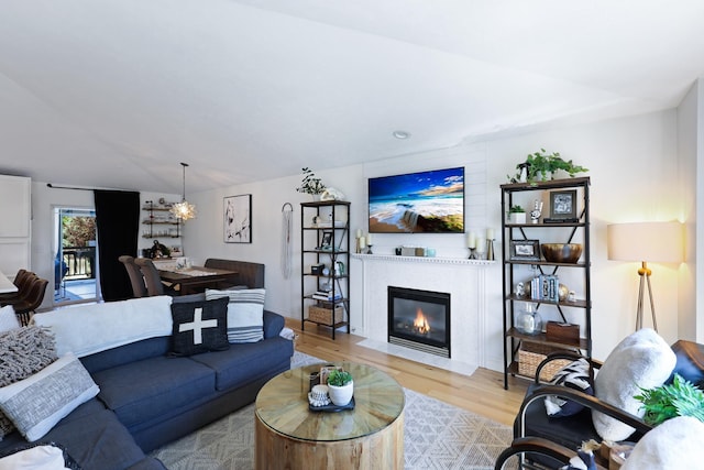 18017 N Lidgerwood Ct, Colbert, WA 99005 - living room featuring wood finished floors, a chandelier, and a fireplace with flush hearth