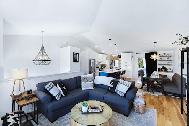 18017 N Lidgerwood Ct, Colbert, WA 99005 - living room featuring lofted ceiling, light wood finished floors, and a chandelier
